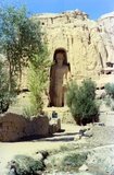The Buddhas of Bamiyan were two 6th century monumental statues of standing buddhas carved into the side of a cliff in the Bamiyan valley in the Hazarajat region of central Afghanistan, situated 230 km (143 miles) northwest of Kabul at an altitude of 2,500 meters (8,202 ft).<br/><br/>

Built in 507 CE, the larger in 554 CE, the statues represented the classic blended style of Gandhara art. The main bodies were hewn directly from the sandstone cliffs, but details were modeled in mud mixed with straw, coated with stucco. This coating, practically all of which was worn away long ago, was painted to enhance the expressions of the faces, hands and folds of the robes; the larger one was painted carmine red and the smaller one was painted multiple colors.<br/><br/>

The lower parts of the statues' arms were constructed from the same mud-straw mix while supported on wooden armatures. It is believed that the upper parts of their faces were made from great wooden masks or casts. The rows of holes that can be seen in photographs were spaces that held wooden pegs which served to stabilize the outer stucco.<br/><br/>

They were intentionally dynamited and destroyed in 2001 by the Taliban, on orders from leader Mullah Mohammed Omar, after the Taliban government declared that they were ‘idols’. International opinion strongly condemned the destruction of the Buddhas, which was viewed as an example of the intolerance of the Taliban. Japan and Switzerland, among others, have pledged support for the rebuilding of the statues.